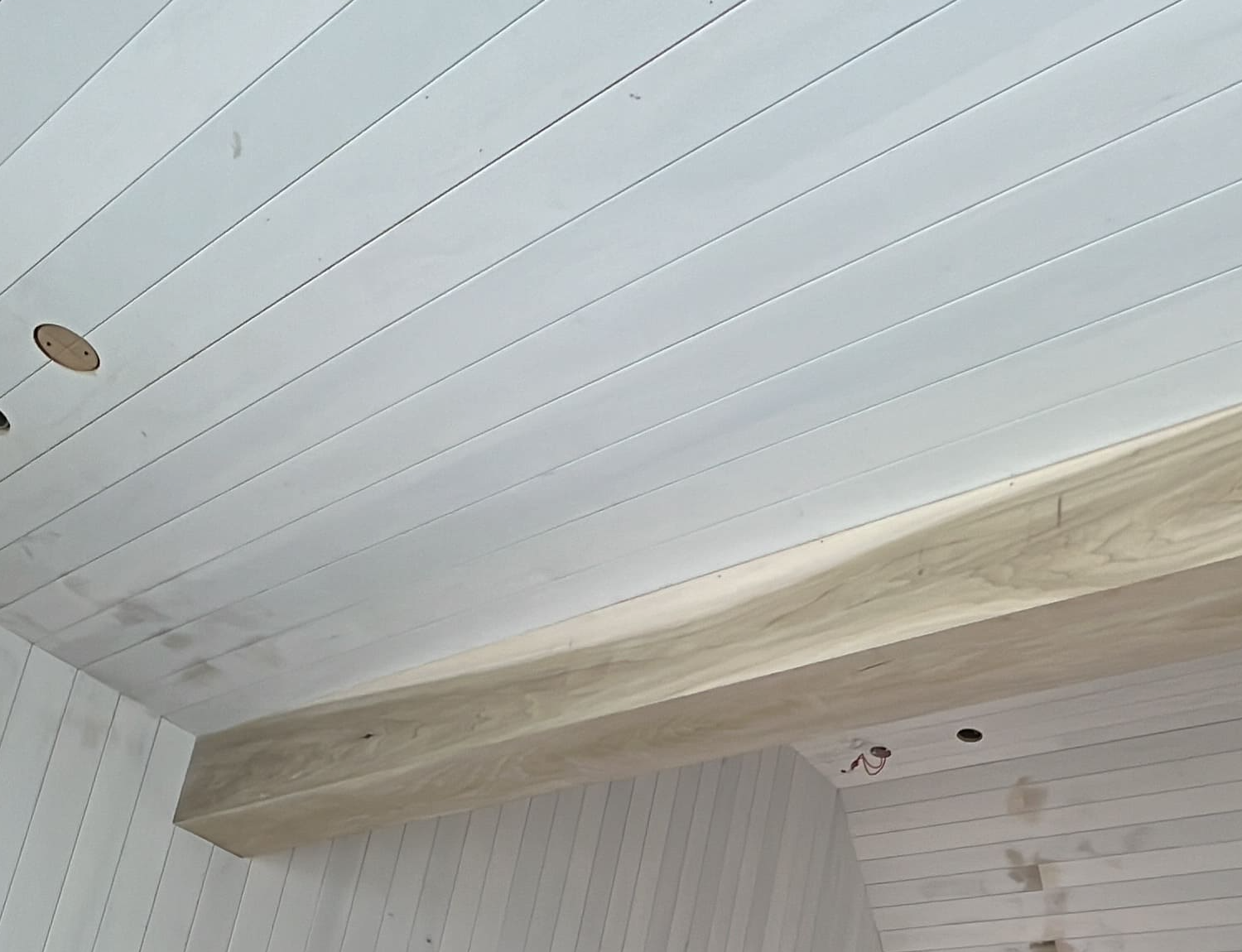 Timber beam over v-groove ceiling